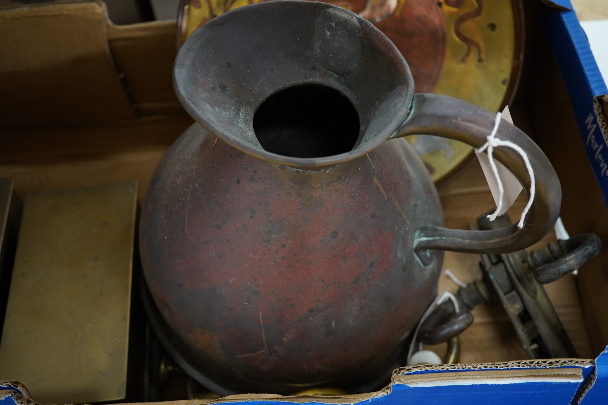 An Art Nouveau ink stand another similar ink stand, a pair of dog door stops, a mixed metal circular tray, a group of hooks and a copper jug, 30cm high (10). Condition - fair